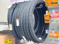 Bicycle tires display in store with tubes and labels on shelf Royalty Free Stock Photo