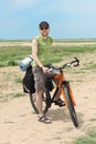 Bicycle tourist standing on road and smiling Royalty Free Stock Photo