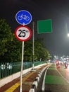 Bicycle track sign and green blank direction sign, in the night Royalty Free Stock Photo