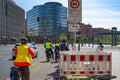 Bicycle traffic at Potsdamer Platz, Berlin. Two police officers from the bicycle squadron are standing at the traffic light
