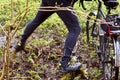 Bicycle, veloplasty, walk, forest, spring, male, to cross the river, river, log, bog Royalty Free Stock Photo