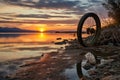 bicycle wheel with deflated tire and a scenic sunset backdrop
