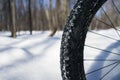 Bicycle wheel in the snow with place for text. Winter bike season