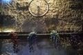 Bicycle wheel on a stone brick yellow wall at night Israel, Dimona, `Mor`, 2018 Royalty Free Stock Photo