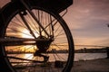 Bicycle wheel on a sunset background. Close up of bicycle wheel with Varna Port atsunset Royalty Free Stock Photo