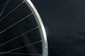 A bicycle wheel without a tire on a black background in the workshop. Bicycle repair. Rim and spokes of a mountain bike wheel Royalty Free Stock Photo