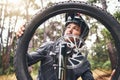 Bicycle, wheel and tyre in forest with man fix problem in zoom or closeup of rim. Cyclist, bike and broken in woods