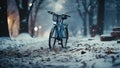 Bicycle in the winter park at night with falling snow. Snowfall