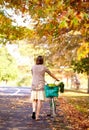 Bicycle, woman and cycling in park for wellness, nature or health on holiday vacation in autumn. Amsterdam, back or