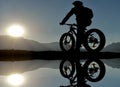 Bicycler on clear lake Royalty Free Stock Photo