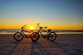 Bicycles on beach at sunset Royalty Free Stock Photo
