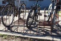 Bicycles are in the bike rack, tied to a metal structure. Ecological urban transport. Saving money on transport in a