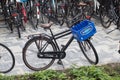 Bicycles locked on bicycle stands in the street. Bavaria box on front rack