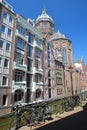 Bicycles parked along Oudezijds Kolk canal, with Basilica of Saint Nicholas Van de Heilige Nicolaas