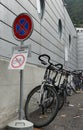 Bicycles parked along a wall of a building.