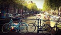 Bicycles parked on the bridge over the canal in Amsterdam Royalty Free Stock Photo
