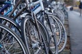 Bicycles parked on a busy street near footpath in Lucerne. Royalty Free Stock Photo