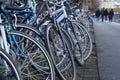 Bicycles parked on a busy street near footpath with defocused peoples. Royalty Free Stock Photo