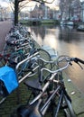 Bicycles parked on canal\'s embankment, Amsterdam, Netherlands Royalty Free Stock Photo