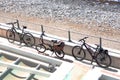 Bicycles are parked on the road near the beach. Royalty Free Stock Photo