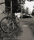 Bicycles parked on the road pavement in the park with city buildings in the blurred background. Sunny summer day. Bicycle parkin. Royalty Free Stock Photo