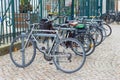 Bicycles are parked in a row in a cityscape. Refusal of cars, urban transport. Hannover, Germany - July 2020