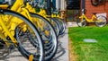 Bicycles parked in row at a rent a bike shop in a park