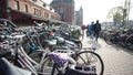 Bicycles parking in front of Amsterdam main station with tourist walking Royalty Free Stock Photo