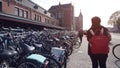 Bicycles parking in front of Amsterdam main station with tourist walking  through Royalty Free Stock Photo