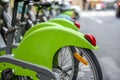 Bicycles for public rental use at parking station in row on city street Royalty Free Stock Photo