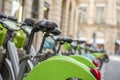 Bicycles for public rental use at parking station in row on street of Paris Royalty Free Stock Photo