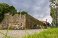 The corner of the old stone wall, the path and bicycles resting on it, Italy Royalty Free Stock Photo