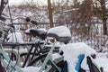 Bicycles with snow on the saddles, winter scene in Amsterdam, horizontal Royalty Free Stock Photo