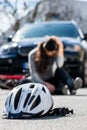 Bicycling helmet on the asphalt after accidental collision