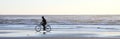 Bicyclist on Beach at Sundown