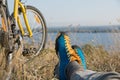 Bicyclist in bright sporty Shoes resting on Grass