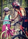 Bicyclist child ride on bicycle path in city. Children go down stairs in park.