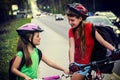 Bicyclist child ride on city bicycle path . Girls wearing helmet .