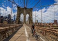 Bicyclist crossing empty Brooklyn Bridge during the coronavirus COVID-19 pandemic lockdown in New York City Royalty Free Stock Photo