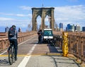 Bicyclist crossing empty Brooklyn Bridge during the coronavirus COVID-19 pandemic lockdown in New York City Royalty Free Stock Photo