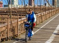 Bicyclist crossing empty Brooklyn Bridge during the coronavirus COVID-19 pandemic lockdown in New York City Royalty Free Stock Photo