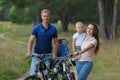 Bicyclist family, leisure in pine forest