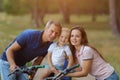 Bicyclist family, leisure in pine forest