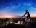 Bicyclist with mountain bike on top of the hill Royalty Free Stock Photo