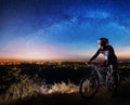 Bicyclist with mountain bike on top of the hill Royalty Free Stock Photo