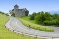 A bicyclist near Castle in Vaduz, Liechtenstein. This castle is