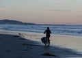 Bicyclist with surfboards rides at sunset near Crystal Pier Royalty Free Stock Photo