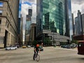 Bicyclist and vehicle traffic round the corner of Wacker Drive and Franklin Street in the downtown Chicago Loop.