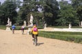 Bicyclists explore grounds of a chateau