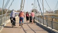 Bicyclists and walkers on the Herrenkrugsteg suspension bridge on their way across the Elbe to Herrenkrugpark